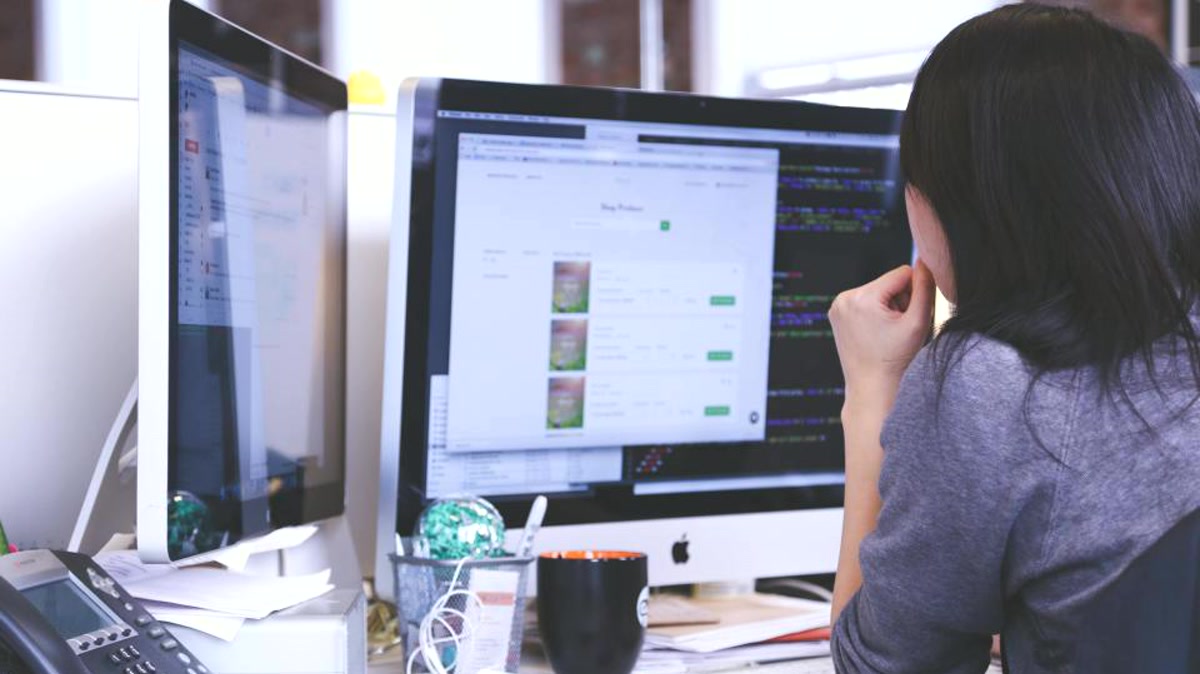 IT professional validating systems and recovery steps at a workstation for Riverside business backup readiness