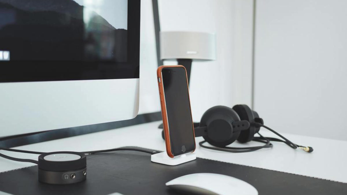 Desk setup with headset phone and monitor used in VoIP outage accountability checklist planning for Riverside businesses